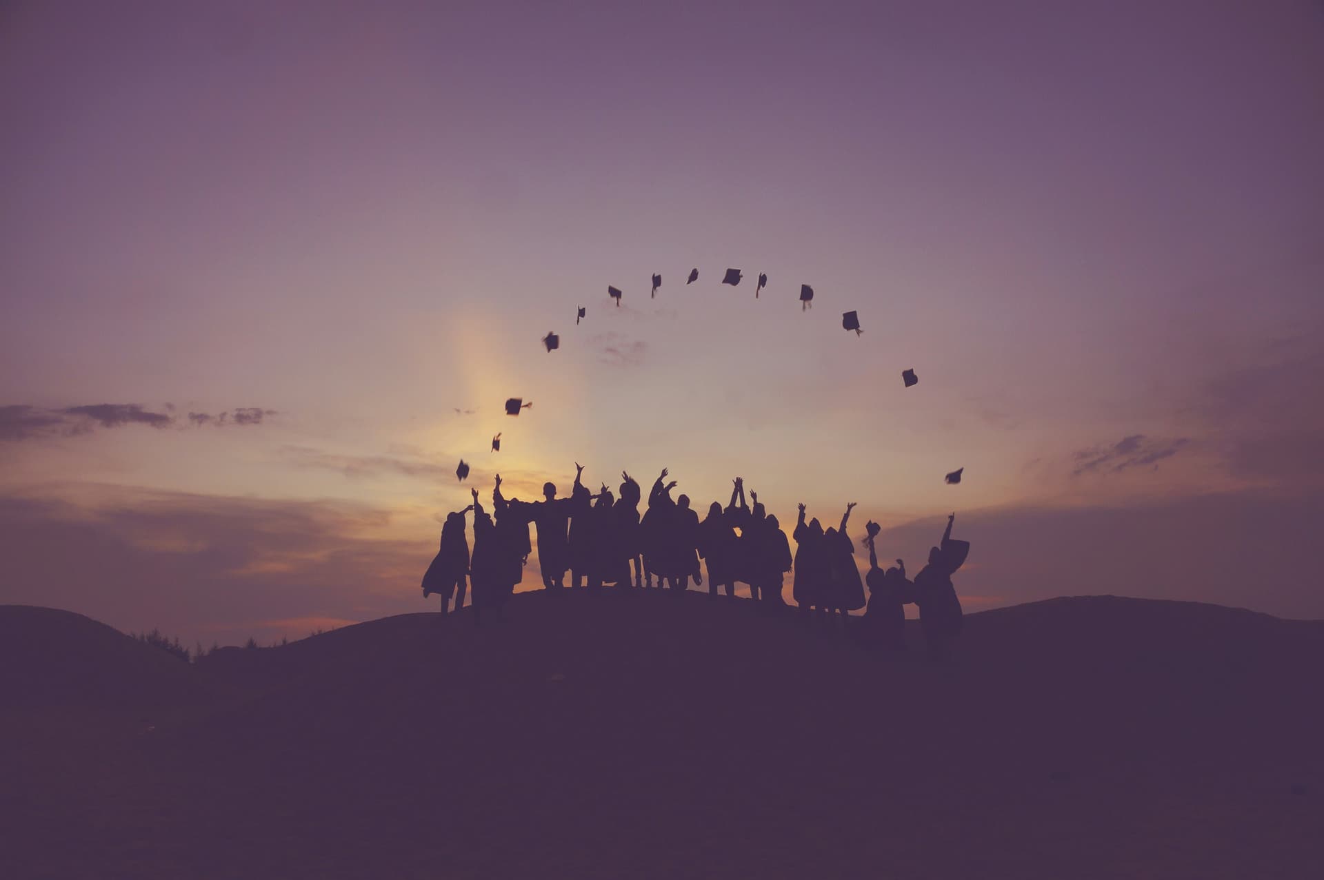 A group of people standing on top of a hill